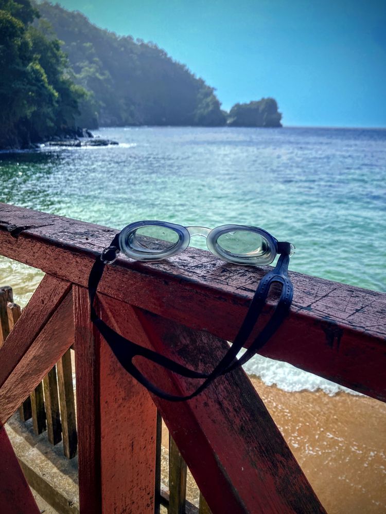 Sunglasses on a beach chair by the ocean